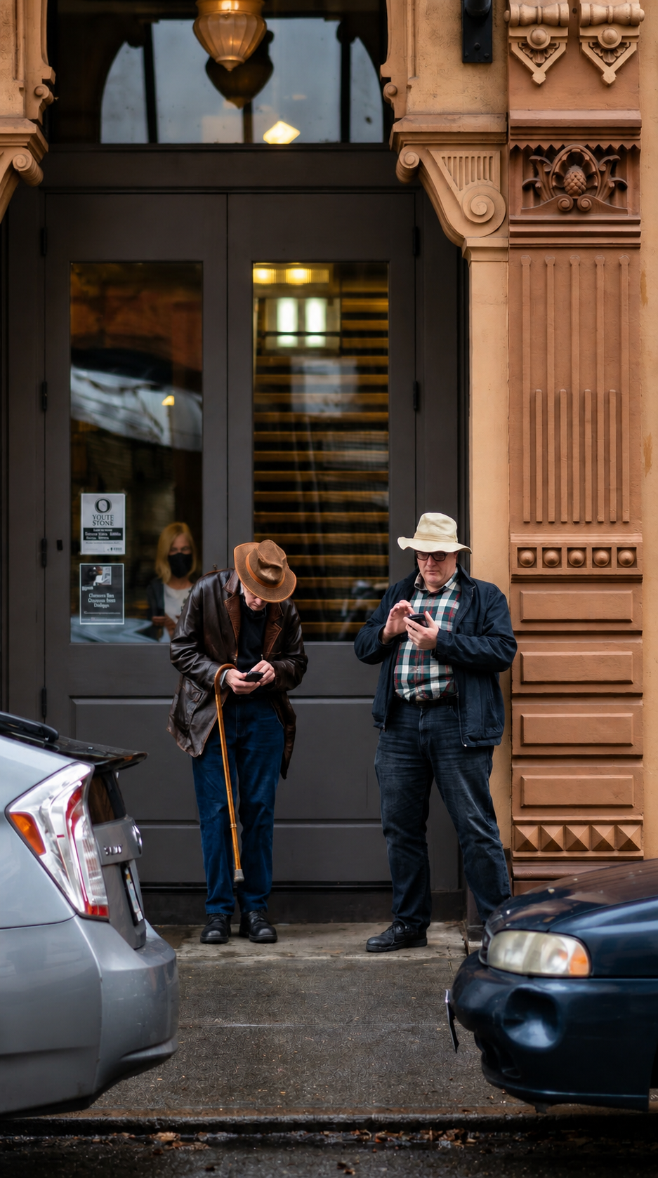 men-outside-ornate-doorway